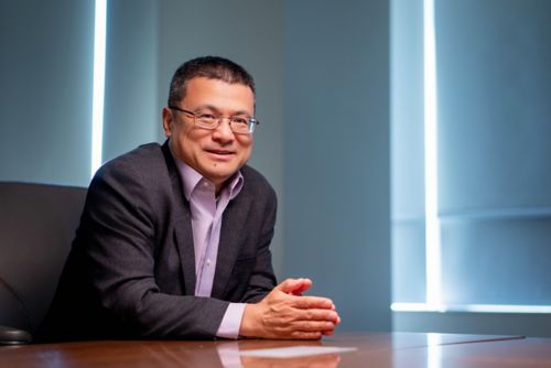 Image of Hongbo Chi in a blue oxford button down shirt