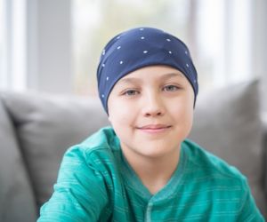 Child with cancer wearing head scarf