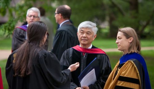 Three people in academic regalia 