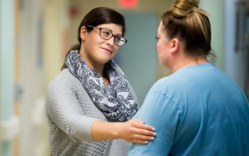 Family member being comforted by hospital staff