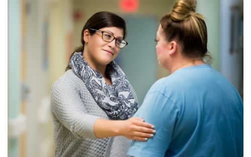 Family member being comforted by hospital staff