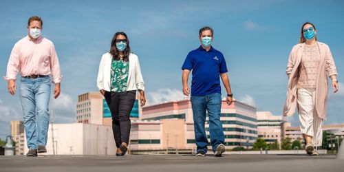 Four people walking outside