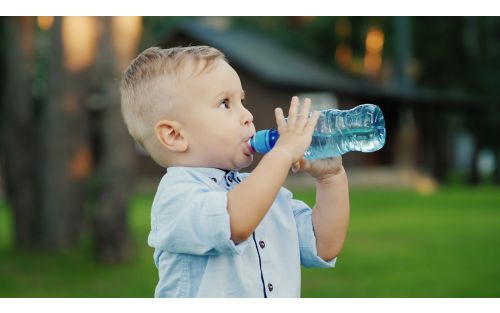 Male toddler sipping from water bottle