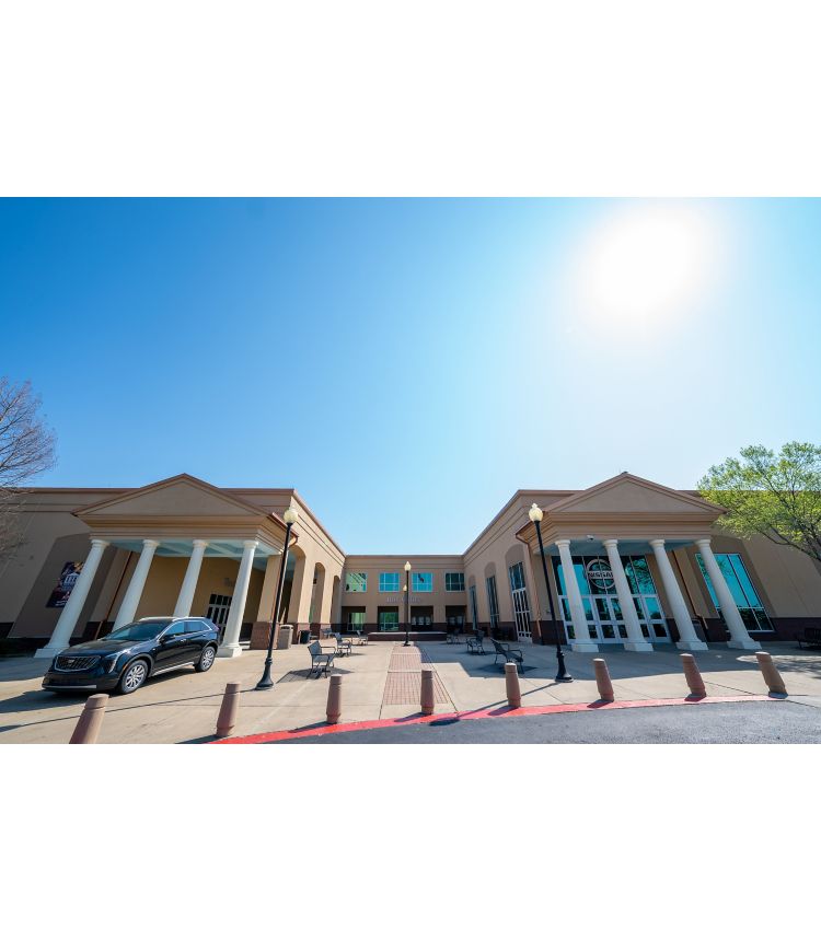 Exterior of large theater building with colonial columns