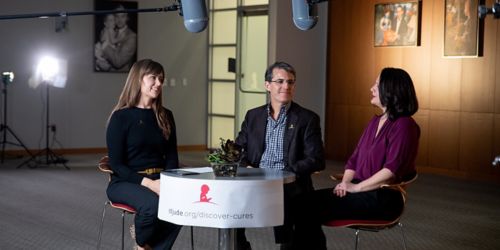 3 people sitting on film set