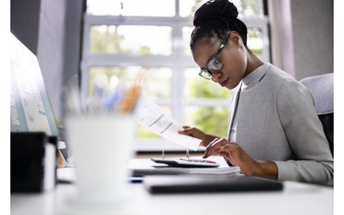 Woman looking at calculator