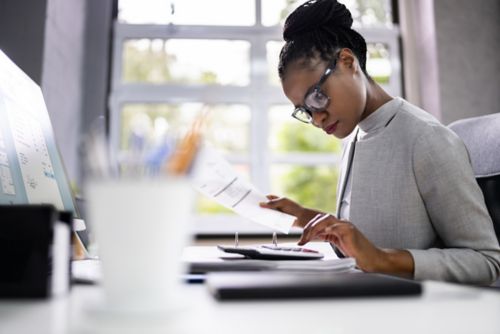 Woman looking at calculator