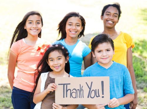 a group of kids holding a sign that says thank you