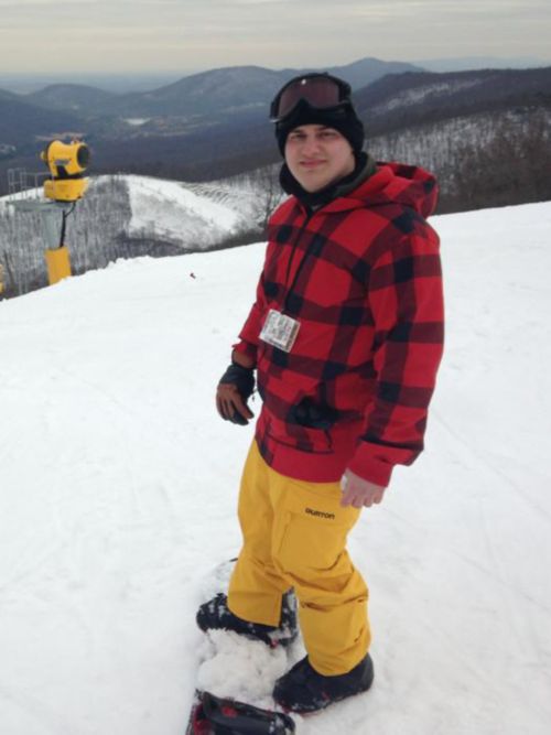 man in plaid jacket snowboarding