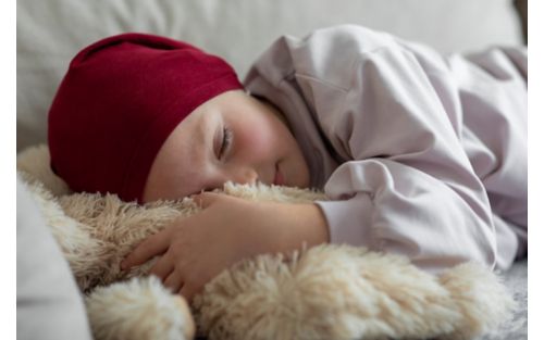 Female child patient sleeping with stuffed animal