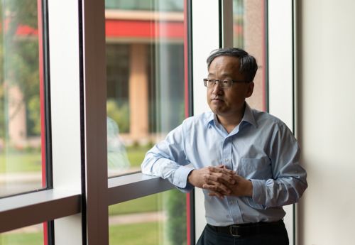 Photo of Yong Feng by a window