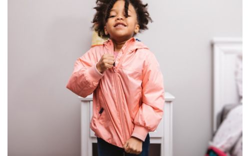 Child zipping up jacket