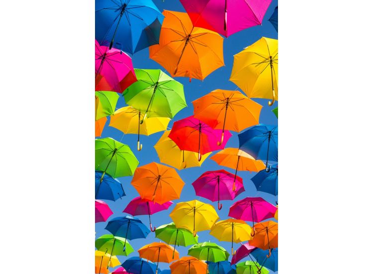 View from below of very colorful umbrellas suspended in the air