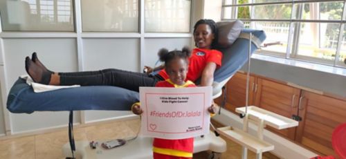 Gabriella holding a sign for the Friends of Dr. Lalala blood drive