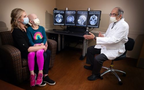 Patient Charlotte Roland and her mother talk with Amar Gajjar