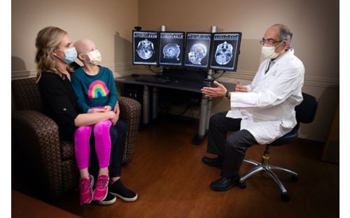 Amar Gajjar, MD., with patient Charlotte and her mother