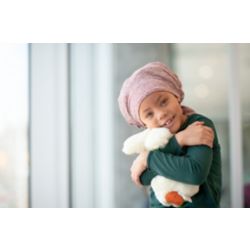 Girl with head scarf holding teddy bear