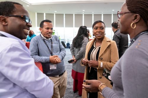 Photo of a group  of people talking at an event