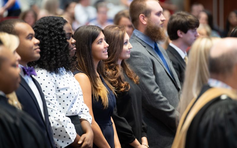 People standing in audience.