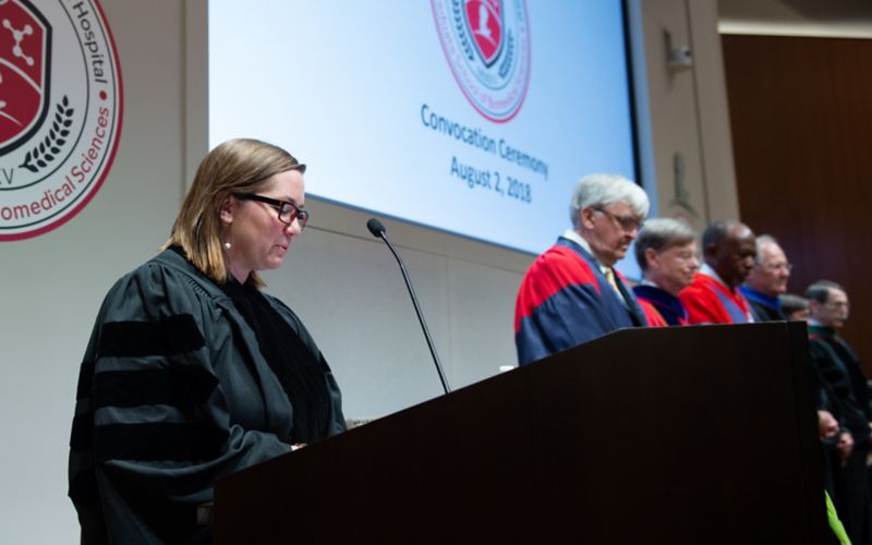 Woman speaking at podium.