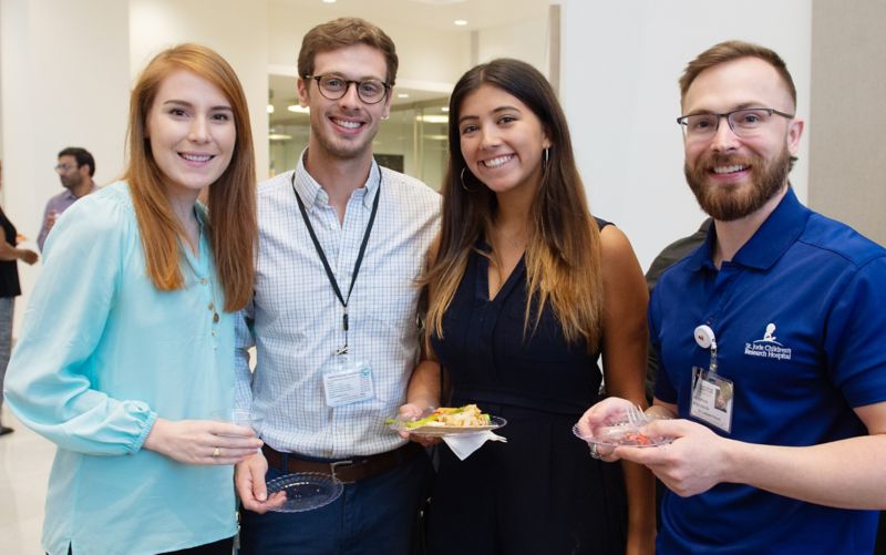 Four people looking at the camera