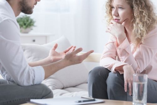 Man talking with female counselor, while both sitting