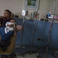 Mother holding baby in medicine room