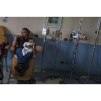 Mother holding baby in medicine room