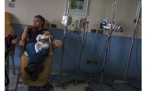 Mother holding baby in medicine room