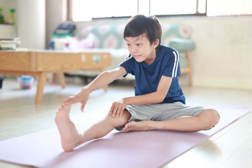 Boy stretching hamstring