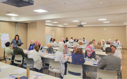 large group of people sitting at cafeteria-style tables
