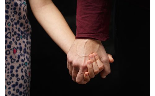 Hand holding child's hand