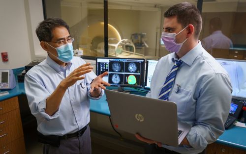 image of Chia-ho Hua and colleague in lab