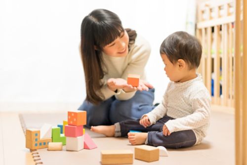 caregiver playing with young boy