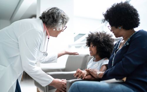 image of doctor talking to patient  and parent