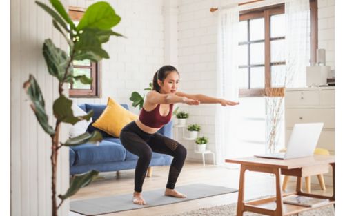 Woman doing a squat on yoga mat