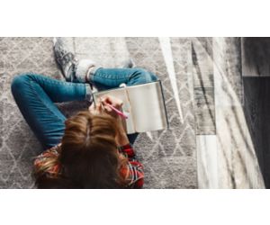 Woman writing in notebook