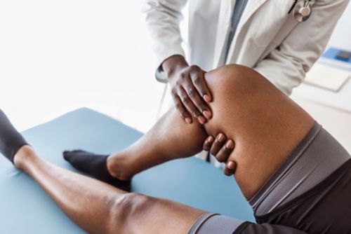 Doctor examining patient's knee