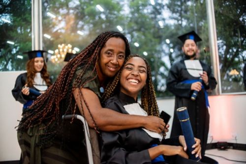 Mother hugs daughter at commencement ceremony