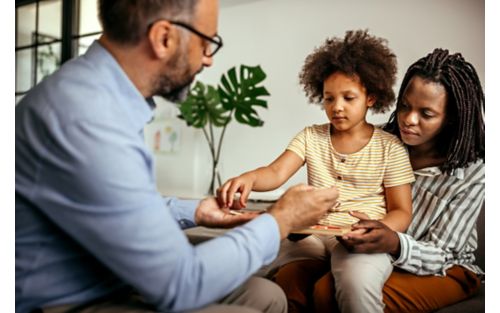 Child playing with doctor during psychology evaluation.