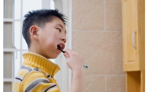 Male child brushing his teeth