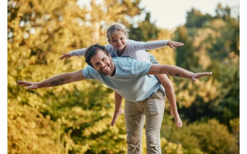 man and girl playing airplane