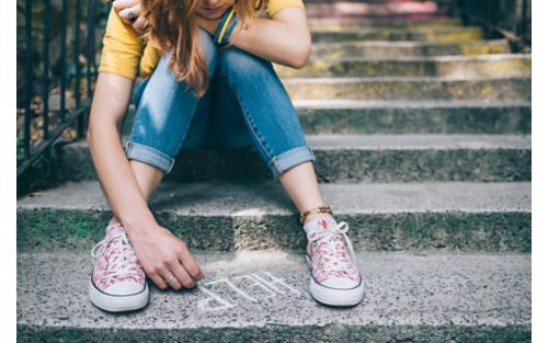 girl-writes-help-on-ground