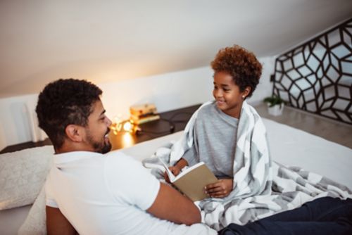 Father talks with daughter before bedtime