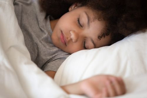 Child sleeping on white pillow