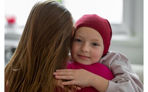 Mother comforts daughter with hug