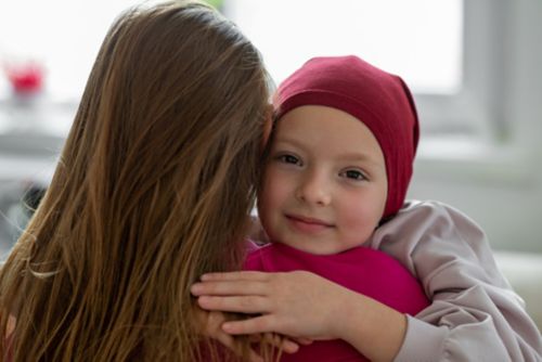 Mother comforts daughter with hug