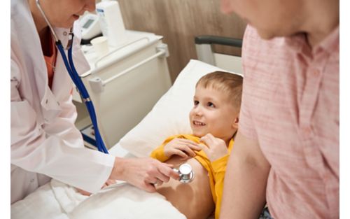 Male child being checked out by doctor