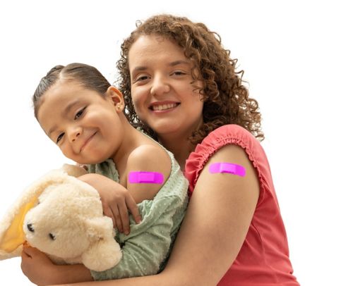 two children with bandaids on their arms after getting shots