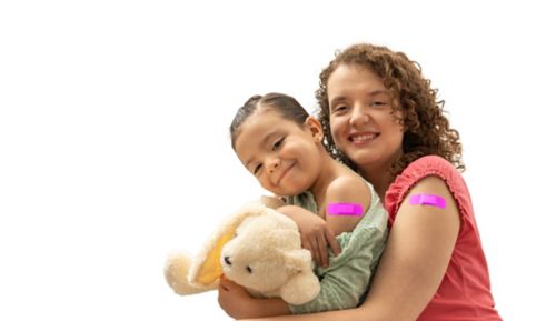 A mother and daughter with their flu vaccine bandaids